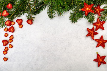 Naklejka na ściany i meble Christmas background with fir tree and red shiny stars.