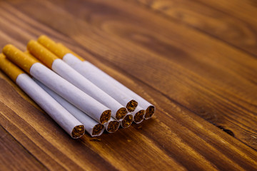Tobacco cigarettes on wooden table