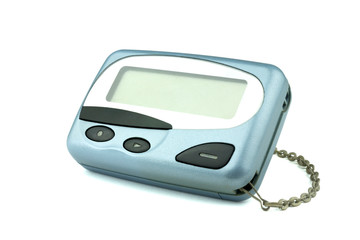 Close-up front old a cyan metallic pager or beeper on white floor, isolated with clipping path on white background.