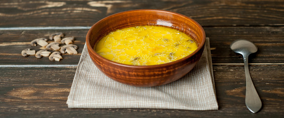 soup with mushrooms on a wooden table