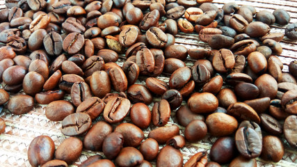Roasted brown coffee beans on cloth background