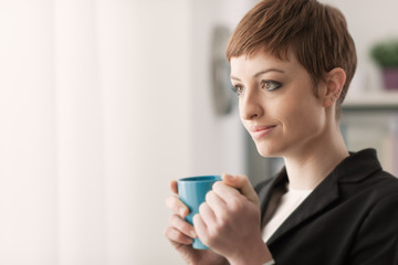 Attractive woman having a coffee break