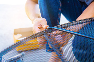 Obraz premium Technician assembling Satellite system by screwdriver for installation.