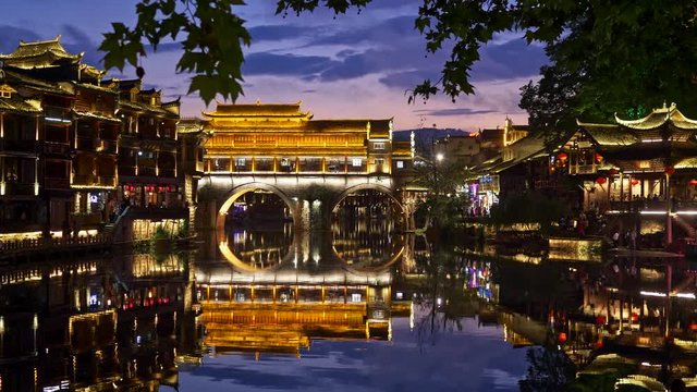 Fenghuang County, China. Bright colorful evening lights of the Ancient Town of Fenghuang located in the western part of Hunan province. The Ancient Town was built in 1704 in Ming and Qing style. 4K