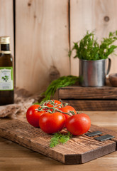 cherry tomatoes and dill on cutting board, organic vegetables