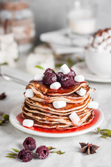 American homemade pancakes or fritters served with raspberry jam and marshmallow, delicious dessert for breakfast