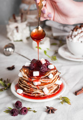 American homemade pancakes or fritters served with raspberry jam and marshmallow, delicious dessert for breakfast