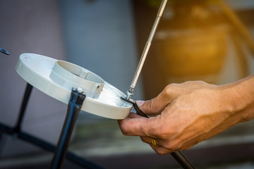 Technician assembling Satellite system by screwdriver for installation.