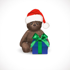 Sitting fluffy cute brown teddy bear with red christmas santa claus hat and blue gift box with green bow. Children's toy isolated on a white background. Realistic vector illustration