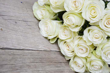 White roses on wooden background