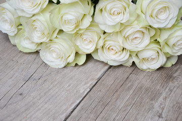 White roses on wooden background