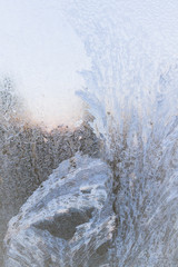 Painted developed frosty patterns on the winter ice window