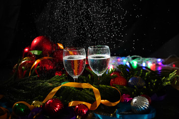 Two glasses of champagne with a Christmas decor in the background