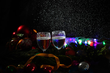 Two glasses of champagne with a Christmas decor in the background