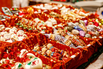 Colorful close up details of christmas fair market. Balls decorations for sales. Xmas market in Germany with traditional decorative toys.