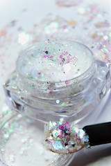 glitter in a jar of white colors. macro