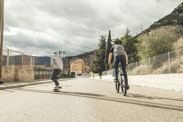 Extreme urban sports concept .Young people with bmx bicycles and skateboards on the street