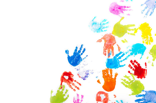 Colored kids handprints on white background with copy space