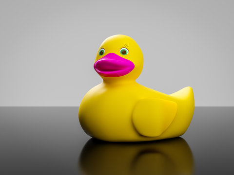 yellow rubber duck with pink mouth and green eyes