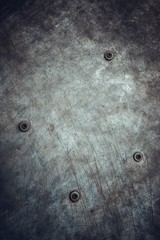 gray background with four iron rusty rivets