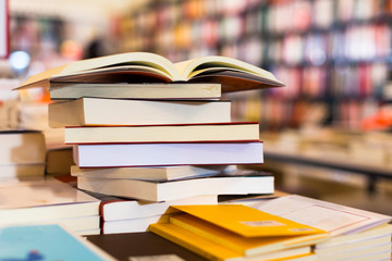 different books lying on table in library