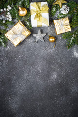 Christmas background with gold and silver decorations on black.
