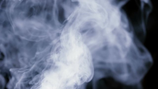 A lot of white smoke isolated on black background slow motion up