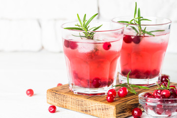 Cocktail with cranberry, vodka, rosemary and ice.