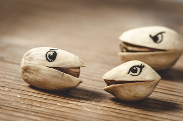 Pistachio nuts with funny drawn on eyes - Realtionship concept
