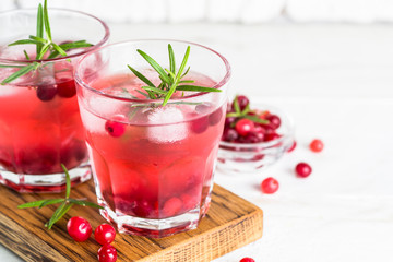 Cocktail with cranberry, vodka, rosemary and ice.