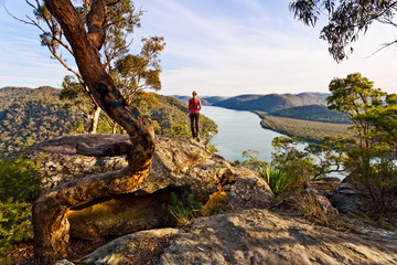 Admiring the scenic river views high from a rocky cliff ledge © Leah-Anne Thompson