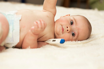 The child at the doctor's office and his ears are cleaned with a cotton swab.