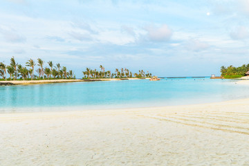 Amazing island in the Maldives ,Beautiful turquoise waters and white sandy beach with  blue sky  background for holiday vacation .