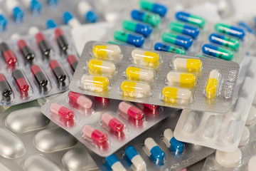 Many colorful pills, tablets, drugs and pharmaceutical substance close-up for patient and doctor