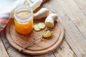 Homemade ginger and lemon jam on wooden background. Natural products to support the immune system...