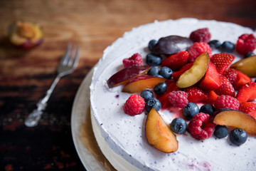 Yoghurt cake with rucola and berries on a vintage table.