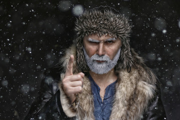 brutal hipster with a gray beard / Christmas winter portrait brutal santa claus, modern trendy guy