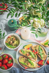 breakfast on the table, fresh snacks and berries, the table is decorated with flowers and candles