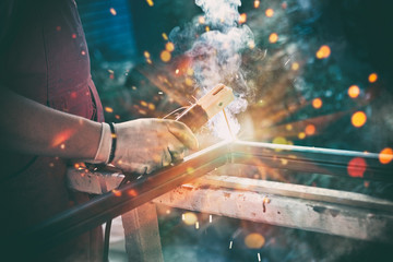 Professional welder welding steel bars