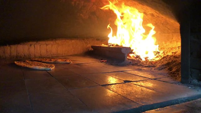 Turkish pizza pide in woodfire, stone cookery