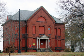 Boarded up and abandoned brick mental hospital asylum building 