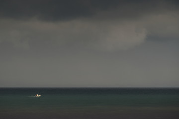 A fisher sailing towards his nets through heavy weather