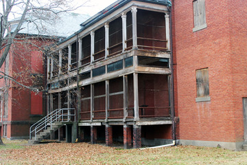Boarded up and abandoned brick mental hospital asylum building 