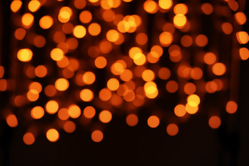 Blurred view of beautiful lights on dark background