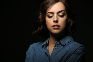 Naklejka premium Portrait of beautiful young woman on dark background