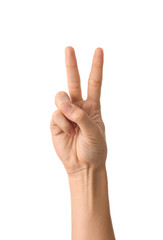 Female hand showing Victory gesture on white background