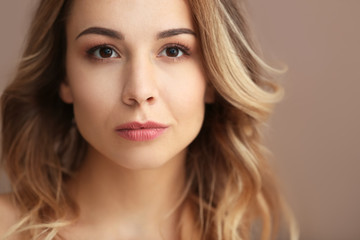 Fototapeta premium Portrait of beautiful young woman on color background