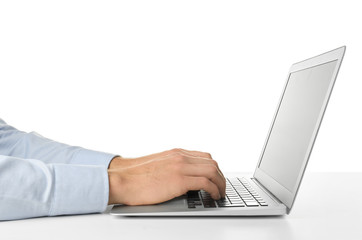 Young businessman using laptop on white background