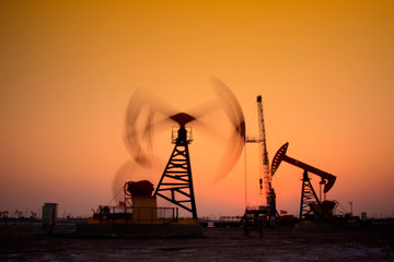 Crank balanced beam pumping unit in Jidong oilfield sunset scenery, closeup of photo
