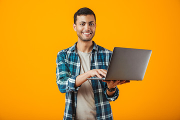 Cheerful young man wearing plaid shirt